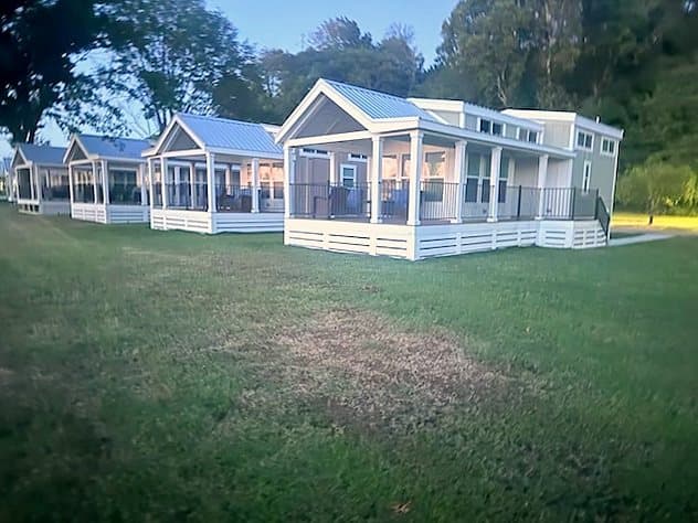 A row of Riverbend homes along the lawn at dusk