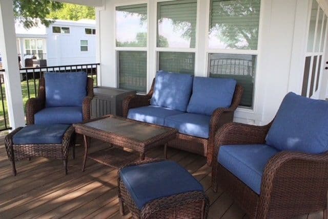 Covered porch with blue wicker sofa and chairs