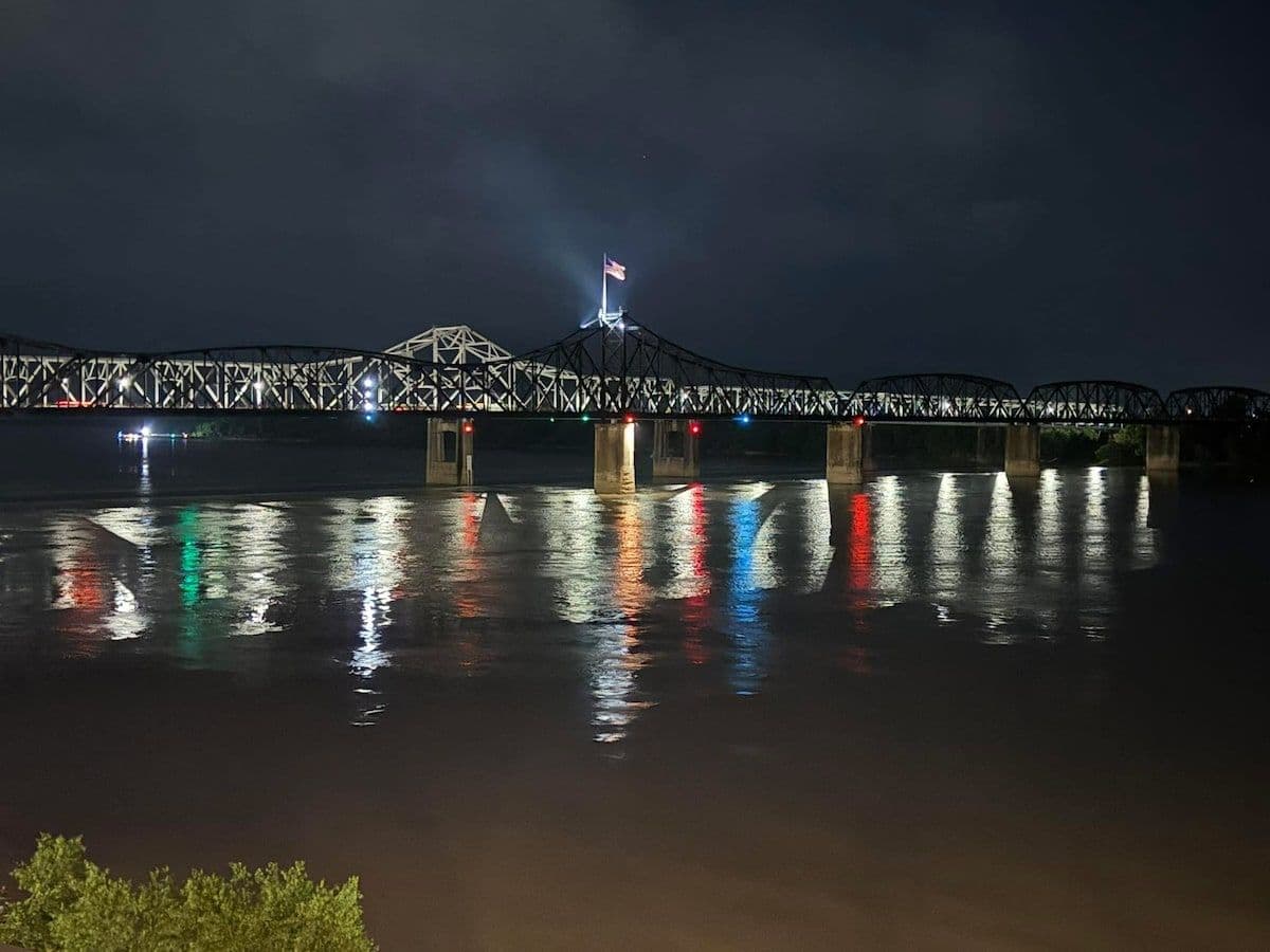 Night view of the Vicksburg bridge lit up over the river