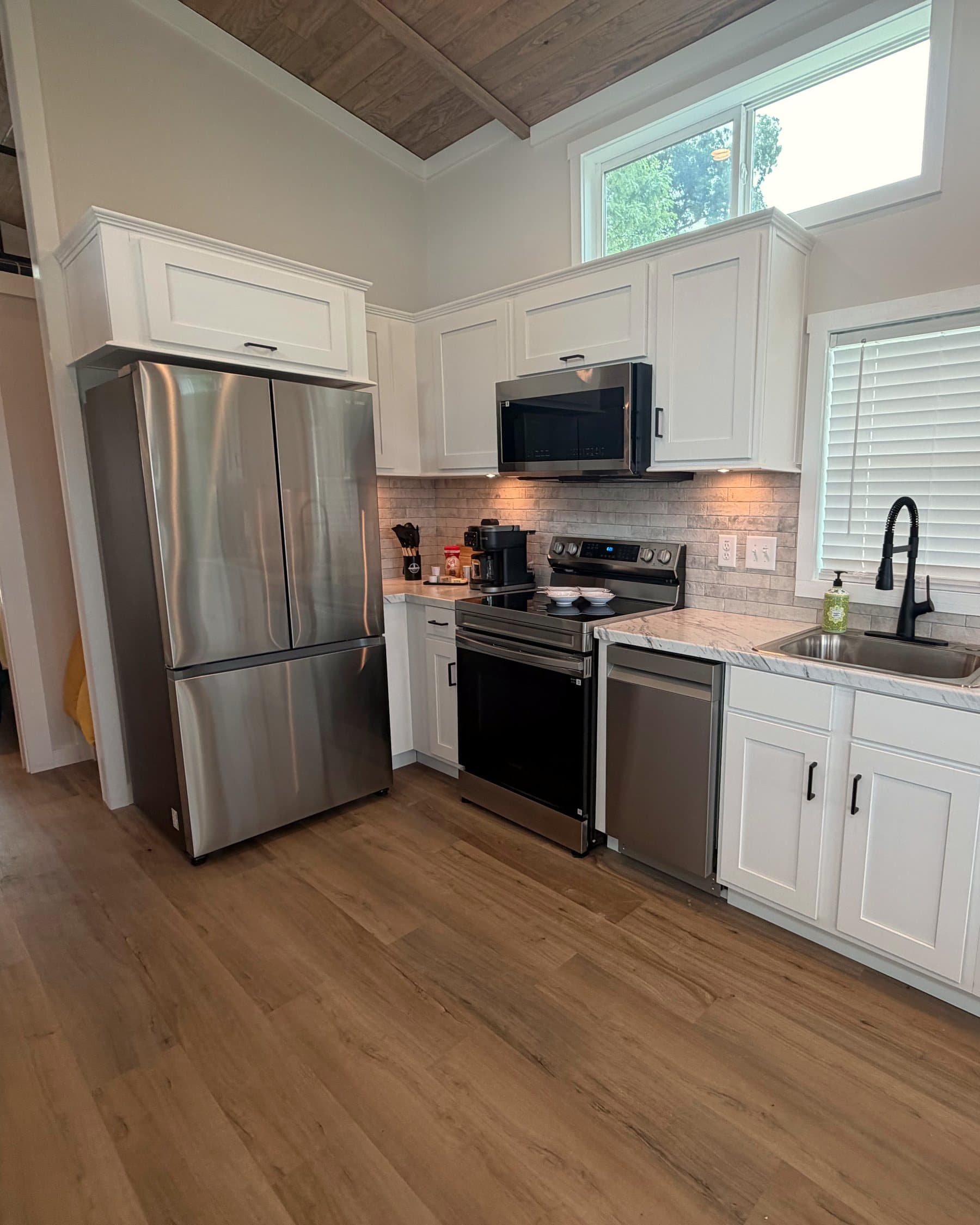 Full kitchen with stove, microwave, and counters in a Riverbend home