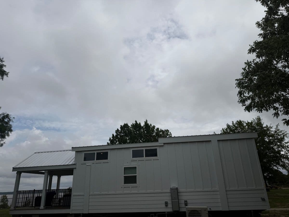 Exterior of the home from the lawn under a cloudy sky